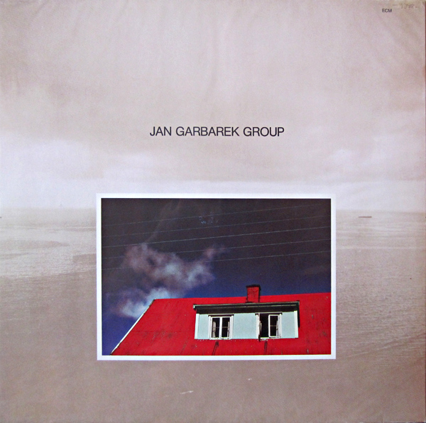 JAN GARBAREK - Photo With Blue Sky, White Cloud, Wires, Windows And A Red Roof cover 